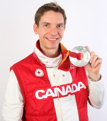 Jason Parker displays the silver medal he won in the 2006 Winter Games