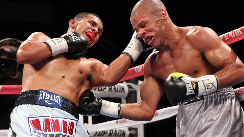 August 17, 2013, Laredo,Texas --- Former 2-time world champion Juan 'El Torito' Diaz (L) stops Adailton DeJesus after DeJesusí corner threw in the towel in the 5th round, Saturday from the Laredo Energy Center in Laredo,Texas. --- Photo Credit : Chris Farina - Top Rank (no other credit allowed) copyright 2013