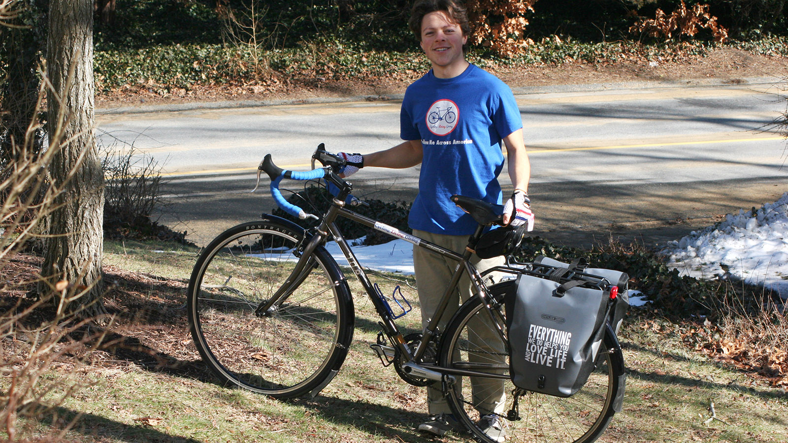 Isaiah Rain Maynard stands next to the bike he will ride across the U.S.