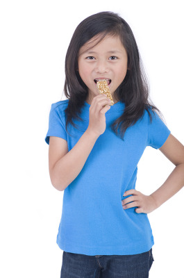 child eating protein bar
