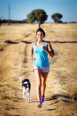 Woman Trail Running with Dog