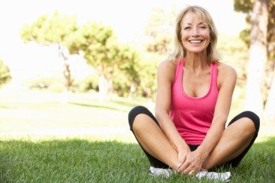 Senior Woman Resting After Exercising In Park