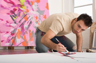 Artist Working on Canvas on Floor of Studio