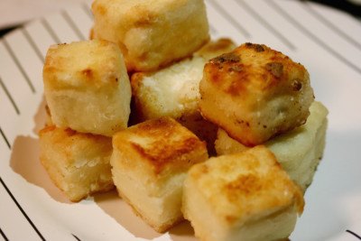 Coat tofu in corn starch and cook in coconut oil to make it crispy.