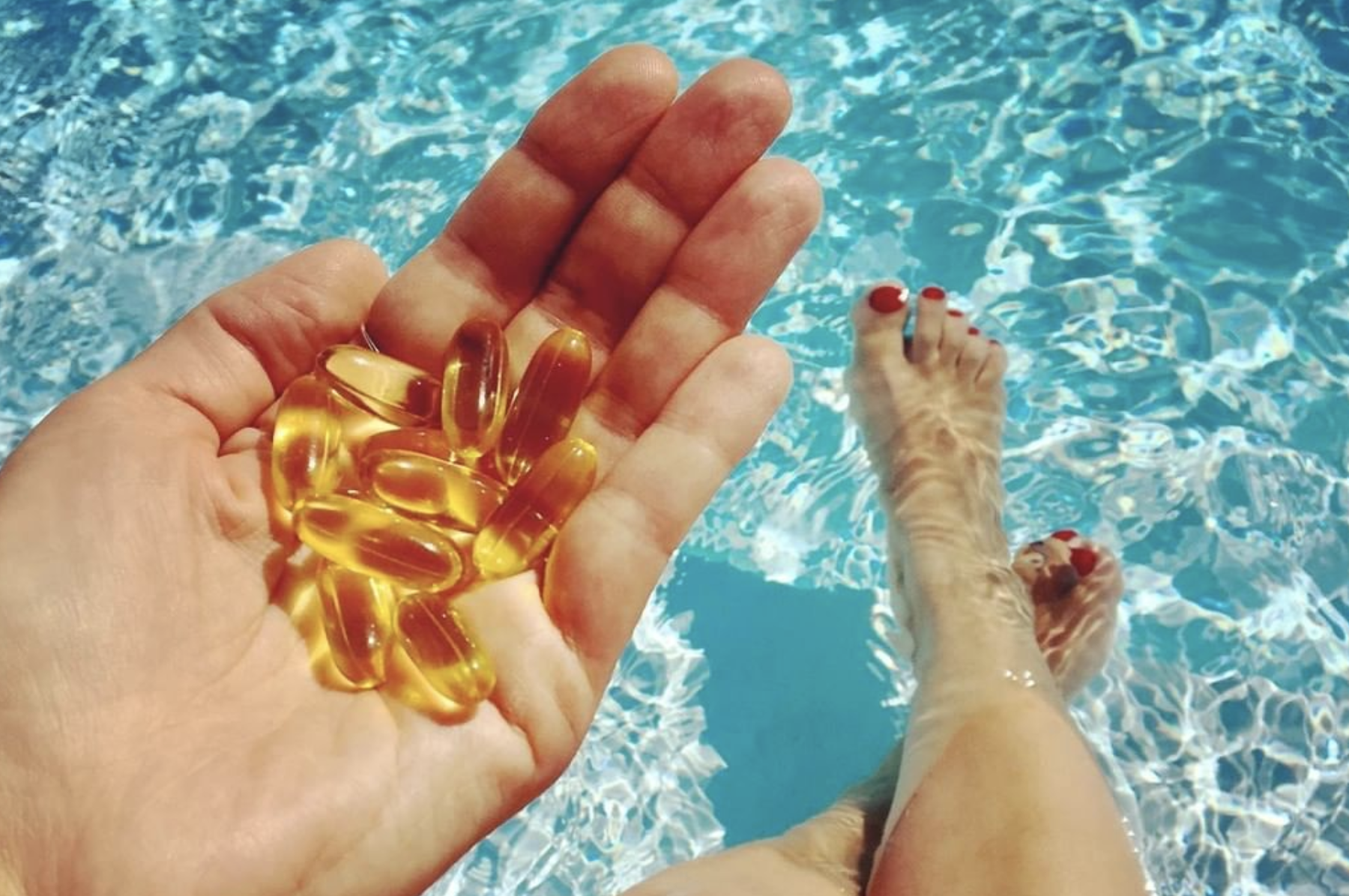 hand-holding-fish-oil-supplements-in-pool-what-s-up-usana